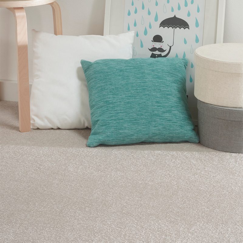 Philadelphia saxony carpet with cushions placed on it in colour flax